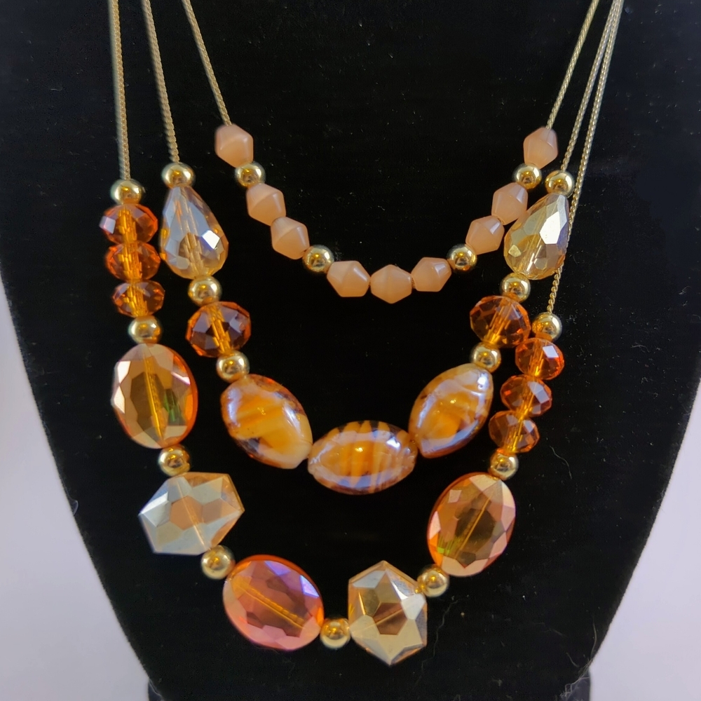 Glass and plastic beaded triple strand Necklace